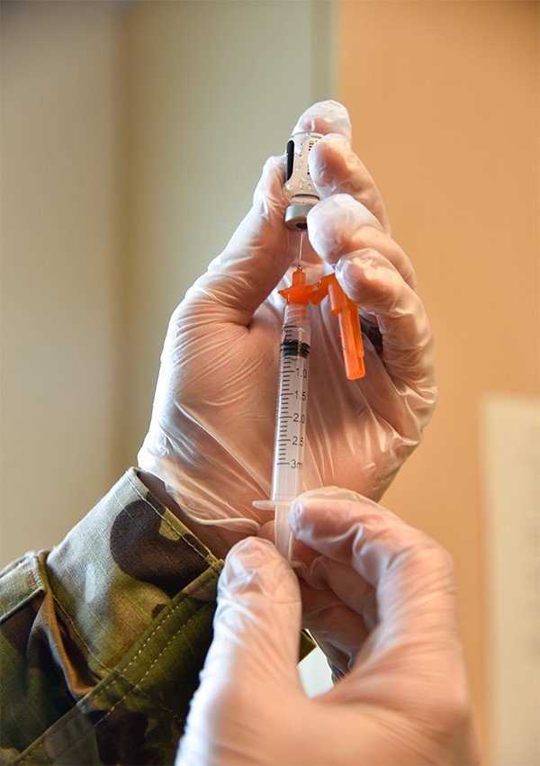 Spc. Anthony Spencer, a healthcare specialist with Cookeville’s 2nd Squadron, 278th Armored Cavalry Regiment, prepares a vaccine dose at the Trousdale County Health Department on June 9. (photo by Lt. Col. Darrin Haas) 