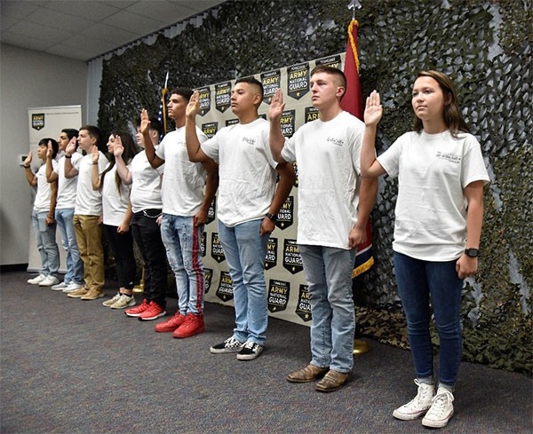 New Soldiers with the Tennessee National Guard raise their right hand and repeat the oath of enlistment with their friends and family in attendance at the Smyrna Bowling Center on July 23. (Photo by Sgt. James Bolen) New Soldiers with the Tennessee National Guard raise their right hand and repeat the oath of enlistment with their friends and family in attendance at the Smyrna Bowling Center on July 23. (Photo by Sgt. James Bolen)