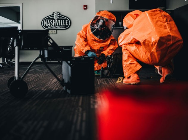 Members of the 45th Civil Support Team inspect an area for possible explosives during their Training Proficiency Evaluation at the Nashville Super Speedway in Lebanon, July 29. U.S. Army North administered the evaluation, which mimics real world events and challenges the unit’s skills and decision-making. (Photo by 1st Lt. Sarah Kohrt)