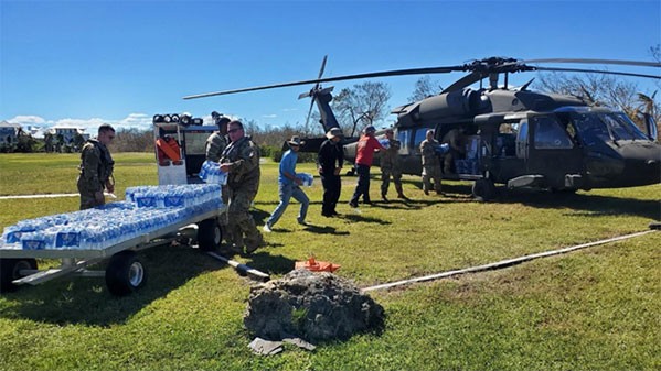 Crewmembers from the Tennessee National Guard’s 1-230th Assault Helicopter Battalion load bottled water on a Blackhawk helicopter for transport to victims of Hurricane Ian. Crews continue to ferry food, water, and other supplies to islands disconnected from the mainland since Ian made landfall last week. (Submitted photo)