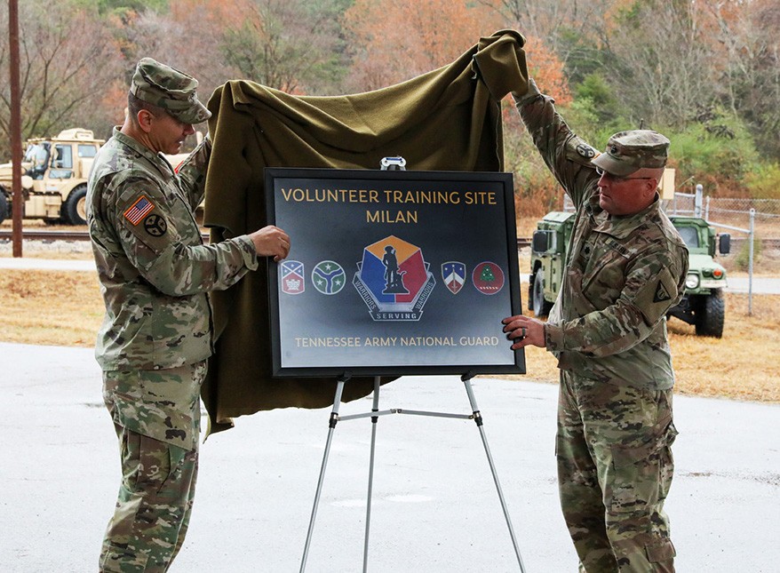 Col. Donnie Hebel, Operations Officer for the Tennessee Army National Guard, and Lt. Col. Kevin Brandon unveil a sign to the Milan Volunteer Training Site during a ceremony in Milan on Dec. 6. (photo by: Capt. Kealy Moriarty)   