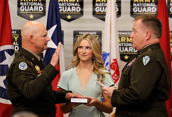 John “Brad” Bowlin is sworn in as a brigadier general in the U.S. National Guard by Maj. Gen. Samuel “Lee” Henry, Commander of the Texas National Guard’s 36th Infantry Division, during Bowlin’s promotion ceremony at the Mt. Carmel National Guard Armory, March 6. Bowlin’s daughter, Emma, assists with the ceremony. (photo by Staff Sgt. Mathieu Perry)