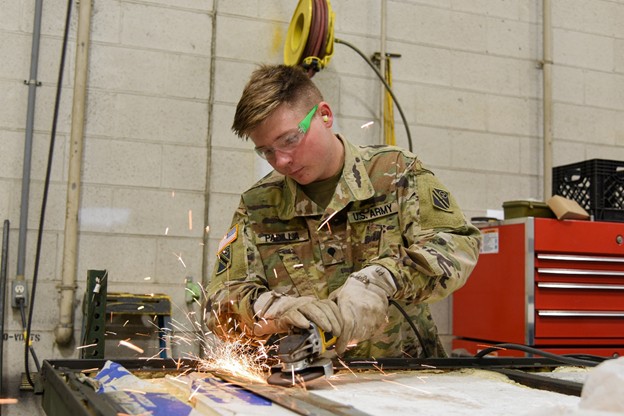Spc. Dustin Padilla prepares a replacement part for a field kitchen. He has worked for Allied Trades for six months at the Volunteer Training Site in Smyrna, Tenn. (Photo by retired Sgt 1st Class Edgar Castro)