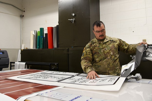 Sgt. Larry Evans creates vinyl signs that are seen in motor pools and reserved parking spots at armories across the state. He works at the Volunteer Training Site in Smyrna, Tenn. (Photo by retired Sgt 1st Class Edgar Castro)