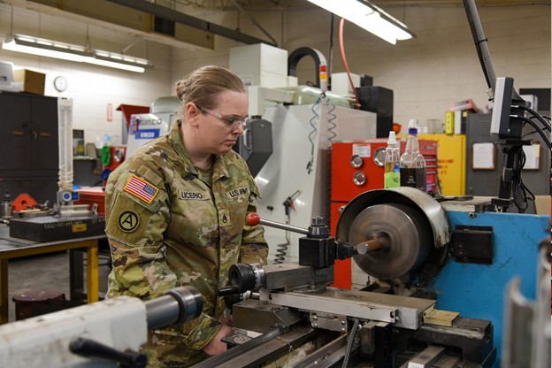 Staff Sgt. Stephanie Licerio uses a grinder to make a new part for a Humvee. She works at the Volunteer Training Site in Smyrna, Tenn. (Photo by retired Sgt 1st Class Edgar Castro)