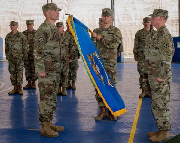 Lt. Col. Mark C. Jordan, commander of the 1-107th Aviation Regiment, Airfield Operations Battalion, displays his unit colors during a transfer of authority ceremony at Camp Lemonnier, Djibouti, Oct. 15, 2021. (U.S. Air Force photo by Senior Airman Dwane R. Young)