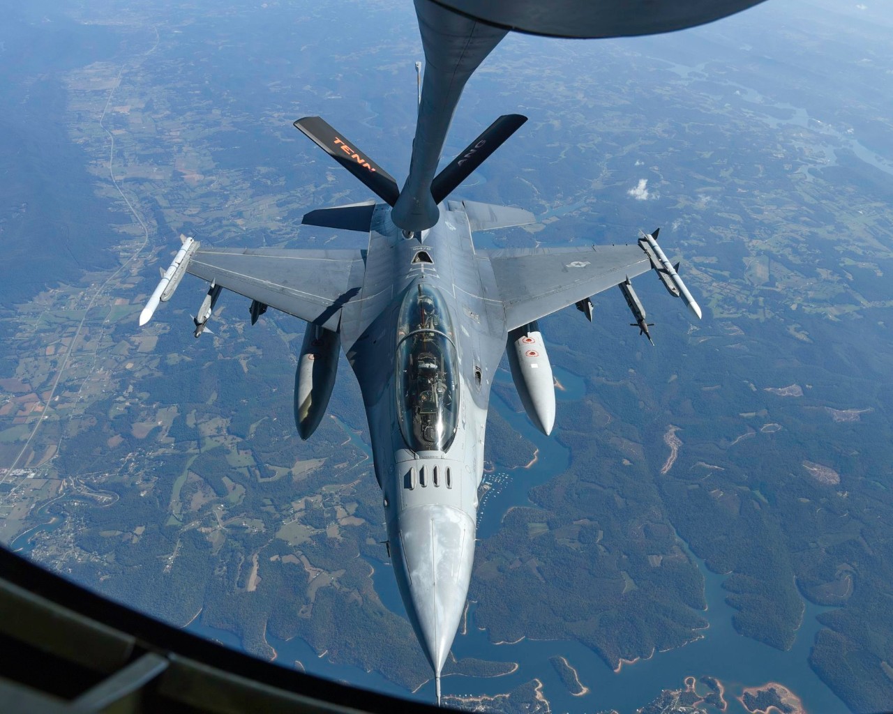 An Air National Guard KC-135 Stratotanker from the 134th Air Refueling Wing refuels a South Carolina Air National Guard F-16 Fighting Falcon while military officials from Bulgarian watch from onboard. (Photo courtesy of the Tennessee National Guard)