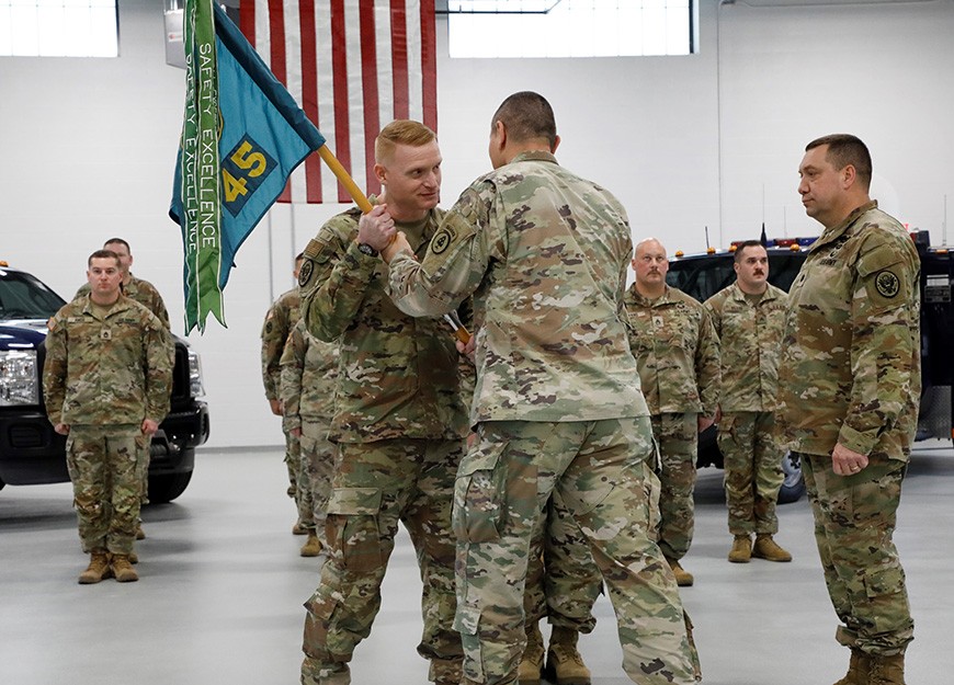 Lt. Col. Trey Robinson takes the guidon from Col. Donnie Hebel, the Operations Officer for the Tennessee National Guard, during the change of command ceremony for the 45th Weapons of Mass Destruction - Civil Support Team in Smyrna on Friday, Mar. 3. (Official Air National Guard Photo)