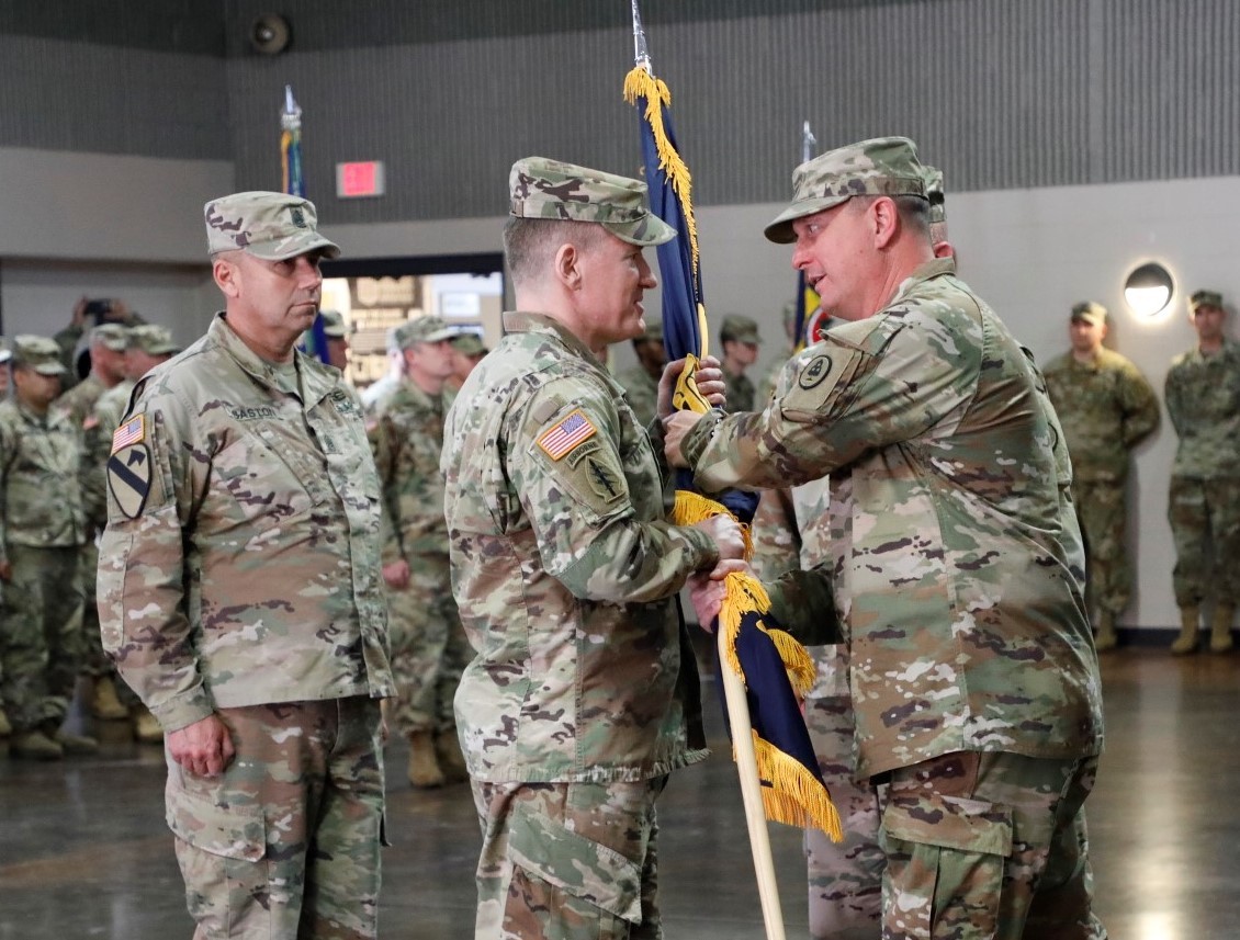 Col. Mark Tyndall, 30th Troop Command’s new commander, takes the unit colors from Col.  Trent Scates, Tennessee’s Assistant Adjutant General-Army, during a change of command ceremony at Tullahoma’s National Guard Armory on Sunday, Mar. 5. (Official Army National Guard Photo)