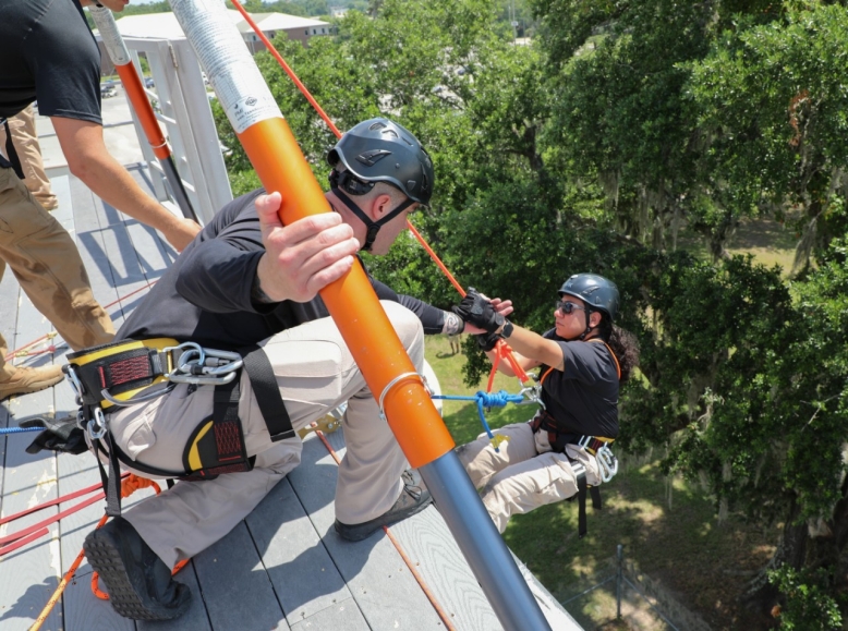 Sgt. 1st Class Jacinda Aguilera, a member of Smyrna’s 45th Civil Support Team, is lifted onto a platform high above Fort Whiting, Alabama, June 13, during a ropes rescue exercise. The 45th CST traveled to southern Alabama with other CSTs in the southeast region, from June 11-16, to sharpen their skillsets in a rapid response exercise. (U.S. Army National Guard photo by Sgt. 1st Class Timothy Cordeiro)