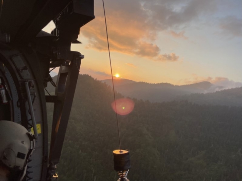 Sgt. Christopher Farrar, a crew chief with the Tennessee Army National Guard, prepares to hoist an injured hiker, who is immobilized and protected on a Skedco stretcher, into a hovering Blackhawk helicopter during a rescue at the Great Smoky Mountains National Park, July 27. (Submitted photo)