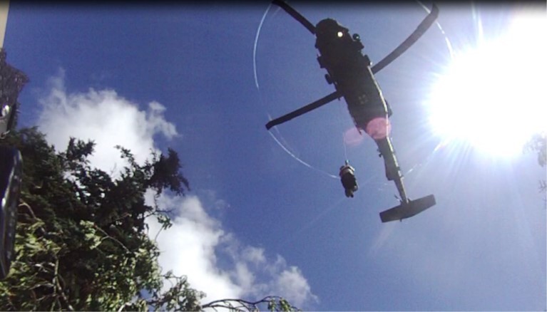 A sick hiker is hoisted into a hovering Tennessee Army National Guard Blackhawk helicopter during a rescue at the Great Smoky Mountains National Park, July 27. (Submitted photo)