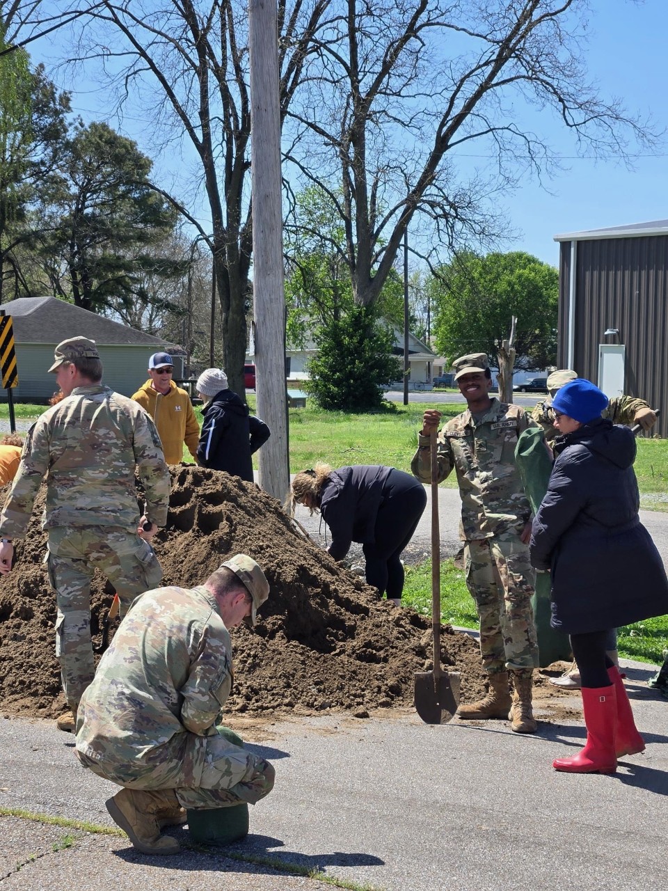 Soldiers from Trenton’s 230th Engineer Battalion help fill sandbags in Finley, April 8, to assist the local community protect areas from flooding. (photo by Spc. Landon Evans)