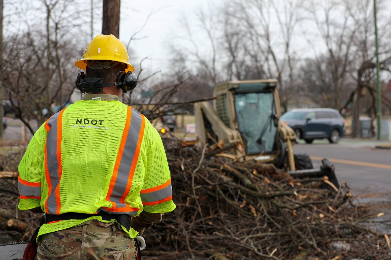 Soldiers with the Tennessee Army National Guard use a skid steer to clear tree limbs and fallen trees blocking roadways near Ellington Pike in Nashville, February 3. Guardsmen are supporting state, county, and local emergency responders as they assist Tennesseans affected by Winter Storm Fern. (photo by Sgt. 1st Class Timothy Cordeiro) Soldiers with the Tennessee Army National Guard use a skid steer to clear tree limbs and fallen trees blocking roadways near Ellington Pike in Nashville, February 3. Guardsmen are supporting state, county, and local emergency responders as they assist Tennesseans affected by Winter Storm Fern. (photo by Sgt. 1st Class Timothy Cordeiro)