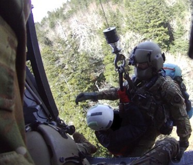 Tennessee Army National Guard UH-60 Blackhawk hoists Sgt. 1st Class John Sharbel and a hiker in medical distress into the aircraft near False Gap Trail, a remote area of the Great Smoky Mountain National Park, southeast of Gatlinburg near the North Carolina border, March 25. (submitted photo)    