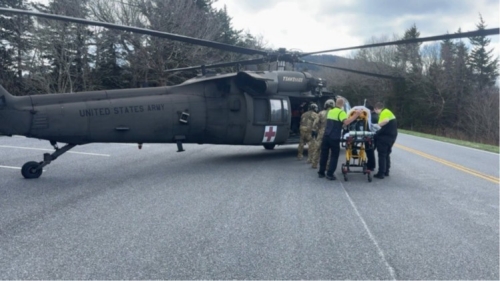 Tennessee Guardsmen and local Emergency Medical Services transfer a park visitor suffering cardiac arrest into a Tennessee Army National Guard UH-60 Blackhawk along Kuwohi Road in the Great Smoky Mountain National Park, April 1. (submitted photo)    