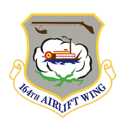 Tennessee National Guard's 164th Airlift Wing logo - A grey shield outlined in gold with a riverboat in the center and a musket at the top. Tennessee National Guard's 164th Airlift Wing logo - A grey shield outlined in gold with a riverboat in the center and a musket at the top.