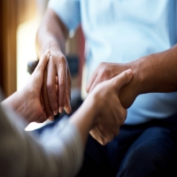 Picture of two people holding hands