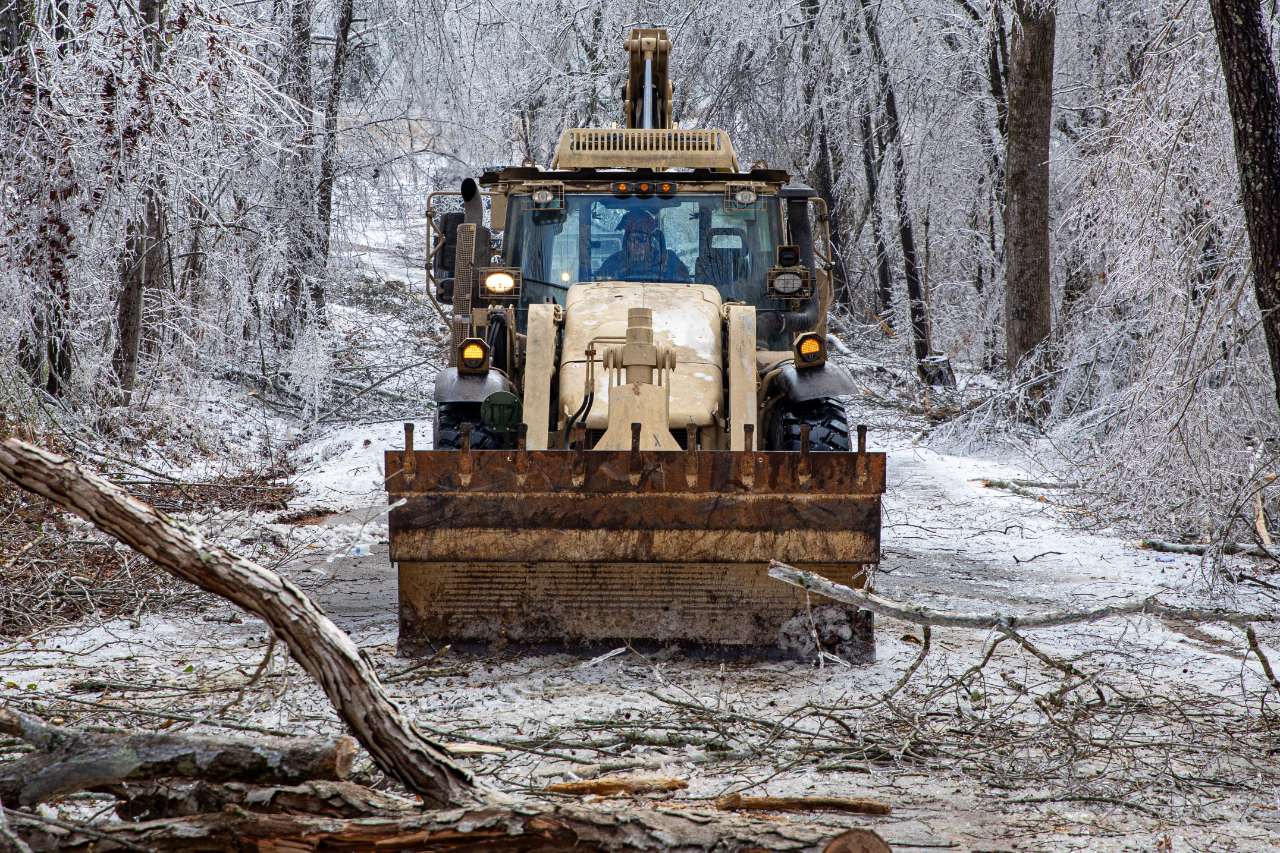 Image of Bulldozer clearing debris from Winter Storm Fern