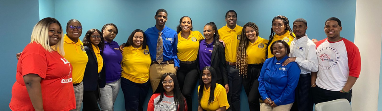 Several students in red, yellow, and blue clothes standing