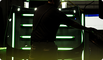 Photo of an auto factory assembly line worker on the job