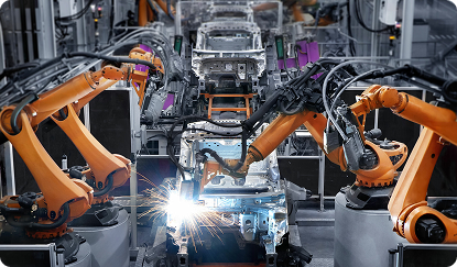 Photo of robotic arms working on an auto manufacturing assembly line