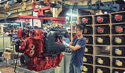 Photo of a mechanic working on an engine in a workshop