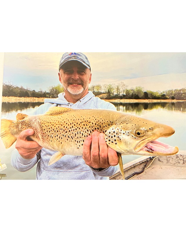 B.J. Ayers, holds his 26” Brown Trout in front of Boone Reservoir in Tennessee 