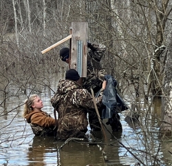 Image of people putting up Wood Duck Box