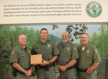 Hunter Daniels holds his award for being named Mississippi Flyway Waterfowl Enforcement Officer of the Year. He is flanked by Region I Major Brian Elkins (left) and Col. Darren Rider, and Region II Major Jeff Skelton.