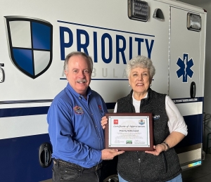 Volunteer Tennessee's Don Sowers presents a certificate of appreciate to Priority OnDemand