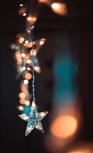 Holiday lights in the background of a star ornament