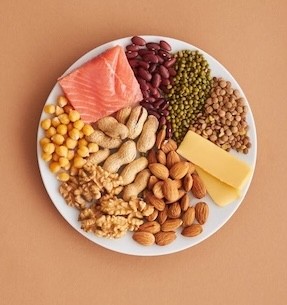 A plate of healthy protein foods, including salmon, beans and nuts