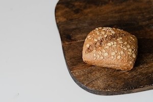Whole Grains 101 A loaf of whole grain bread on a cutting board