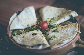 cheesy egg quesadilla with spinach on a plate