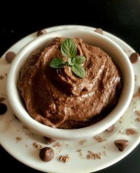 Chocolate Hummus a bowl of chocolate hummus with mint garnish on top