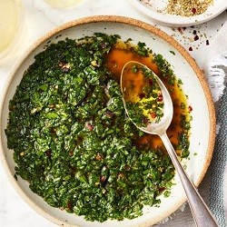 chimichurri sauce in a bowl with a spoon