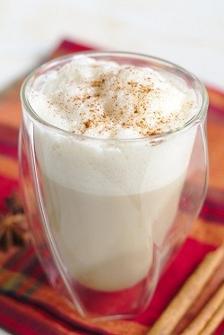 a latte in a clear glass cup 