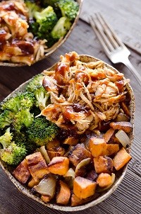 rs_bbq_chicken_sweet_potato_bowls an aluminum container with barbeque chicken, broccoli and sweet potatoes