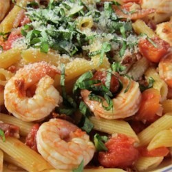 close-up of penne pasta with shrimp and melted cheese