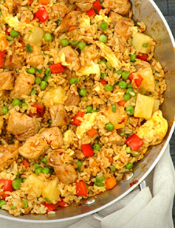 sweet and sour pork fried rice in a pan