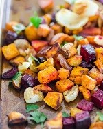 assorted roasted vegetables on a baking sheet