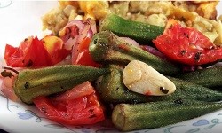 roasted okra, tomatoes and garlic on a plate