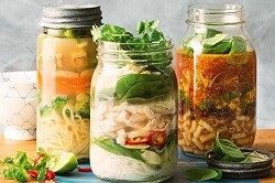 three mason jars full of minestrone soup ingredients