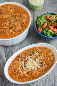 two bowls of vegetarian lasagna soup with a side salad