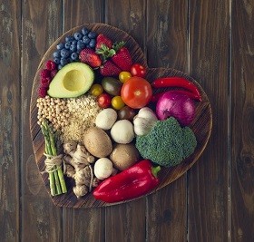 fresh food in a heart shape on a wooden counter