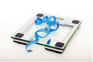 A scale with a tape measure on top of it