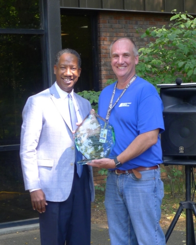 TDLWD Deputy Commissioner Dewayne Scott and Jeff Jansen, President and general manager of Manufacturing Sciences Corporation, standing with award