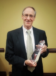 Dr. Hazlewood holding the Sue Ann Head honorary Trophy