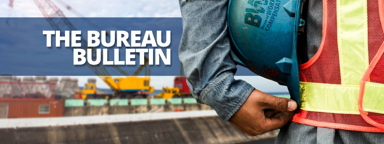 487678872 The Bureau Bulletin header graphic featuring a closeup of a construction worker holding a hard hat between their arm and their waist.
